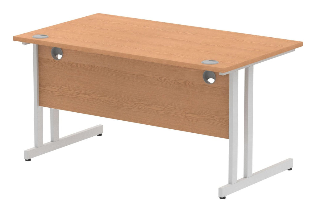 Impulse Night straight desk with cantilever legs, shown in oak with a silver frame, view from the back at an angle
